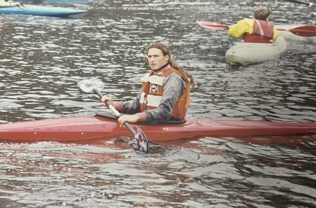 A young Martyn Church paddling a red kayak