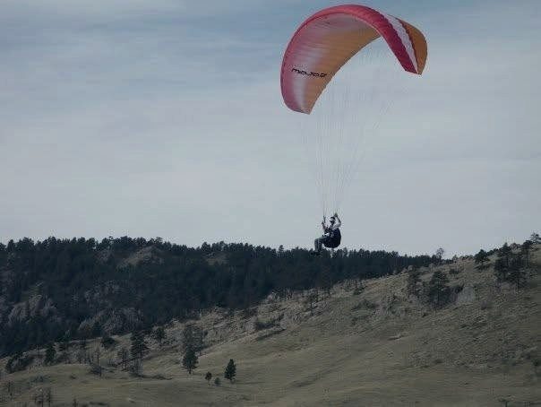 A paraglider above the Boulder foothills